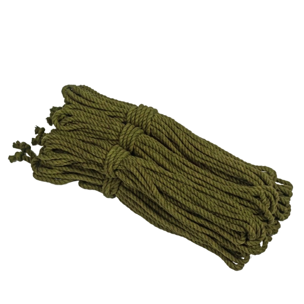 Bundle of green cotton rope on a light gray background